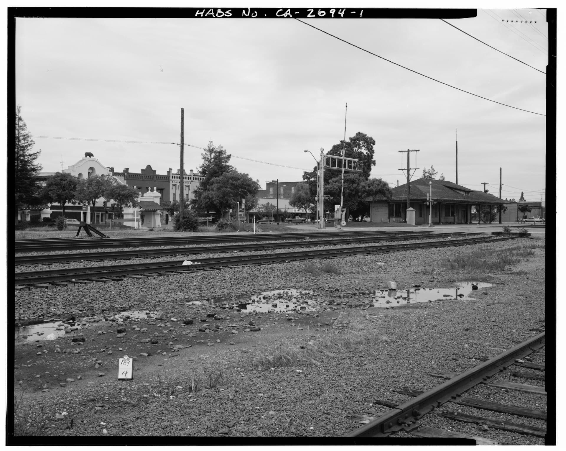 Historic view across railroad tracks toward Lodi's Southern Pacific depot and Mission Arch